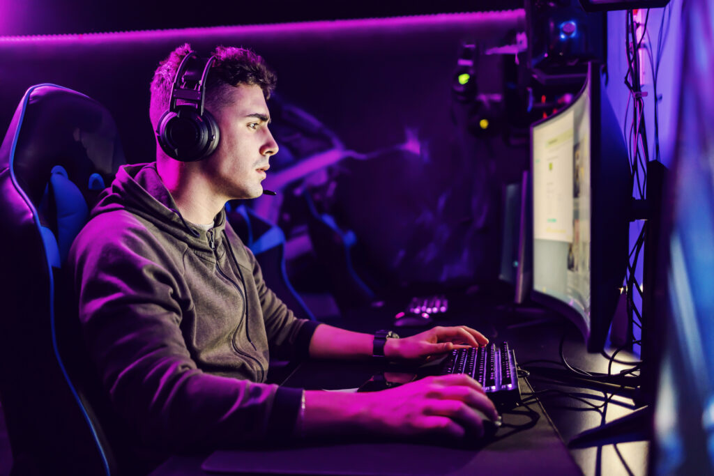 focused-gamer-playing-online-game-modern-computer-gaming-room