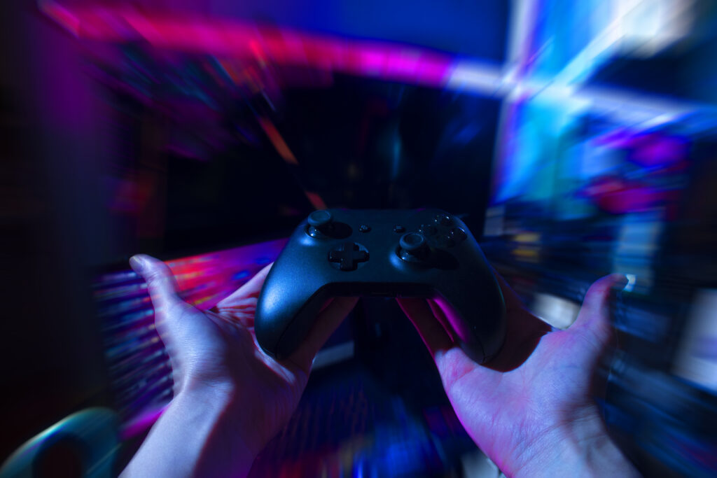 gamer-playing-online-game-with-joystick-controller-neon-glow-dark-cyberpunk-room-gaming-esports-challenge-tournament-streaming-streamer-with-analog-device-living-house (1)