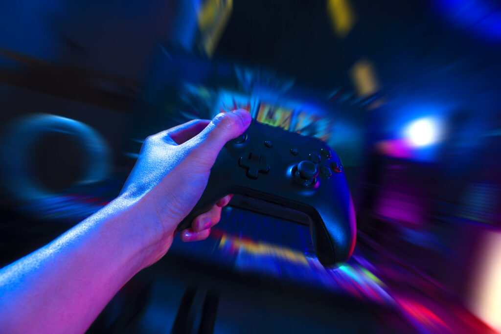 gamer-playing-online-game-with-joystick-controller-neon-glow-dark-cyberpunk-room-gaming-esports-challenge-tournament-streaming-streamer-with-analog-device-living-house